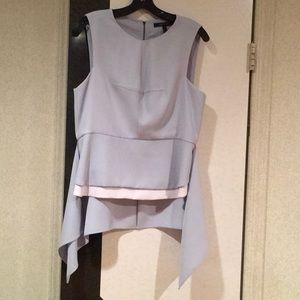 Women’s top,with side flairs. Pale blue. Polyester. Never worn